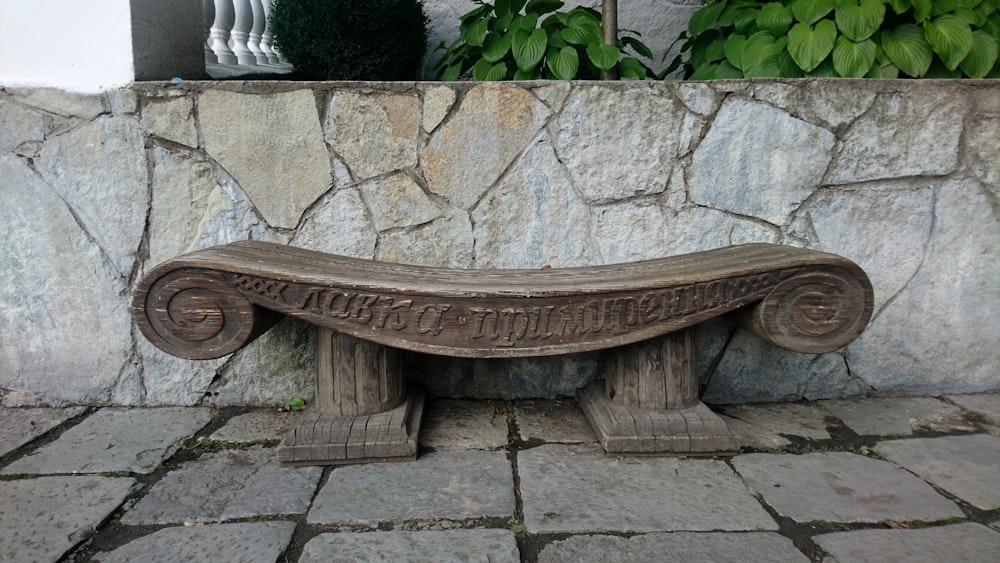 a bench on a stone wall