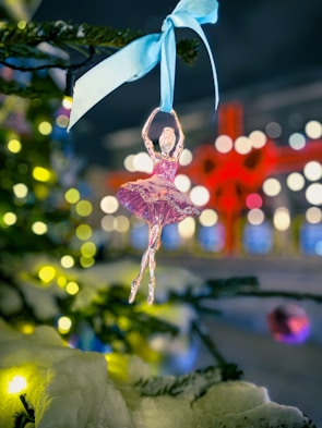 Decorated glass ball featuring delicate dot painting in soft pastel colors.