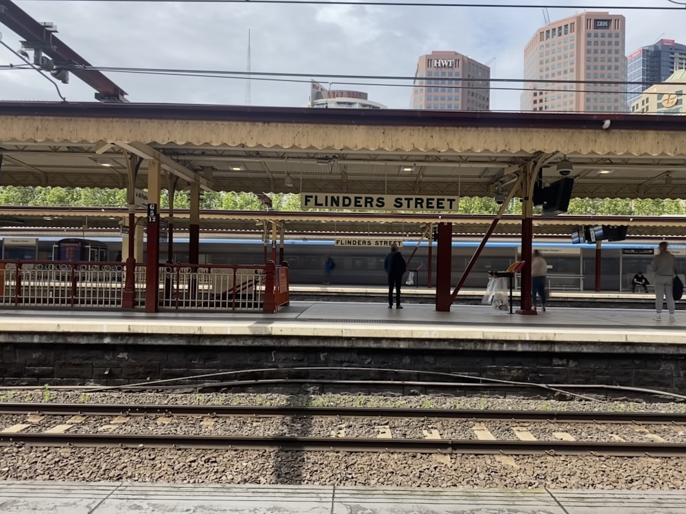 a train station with people waiting