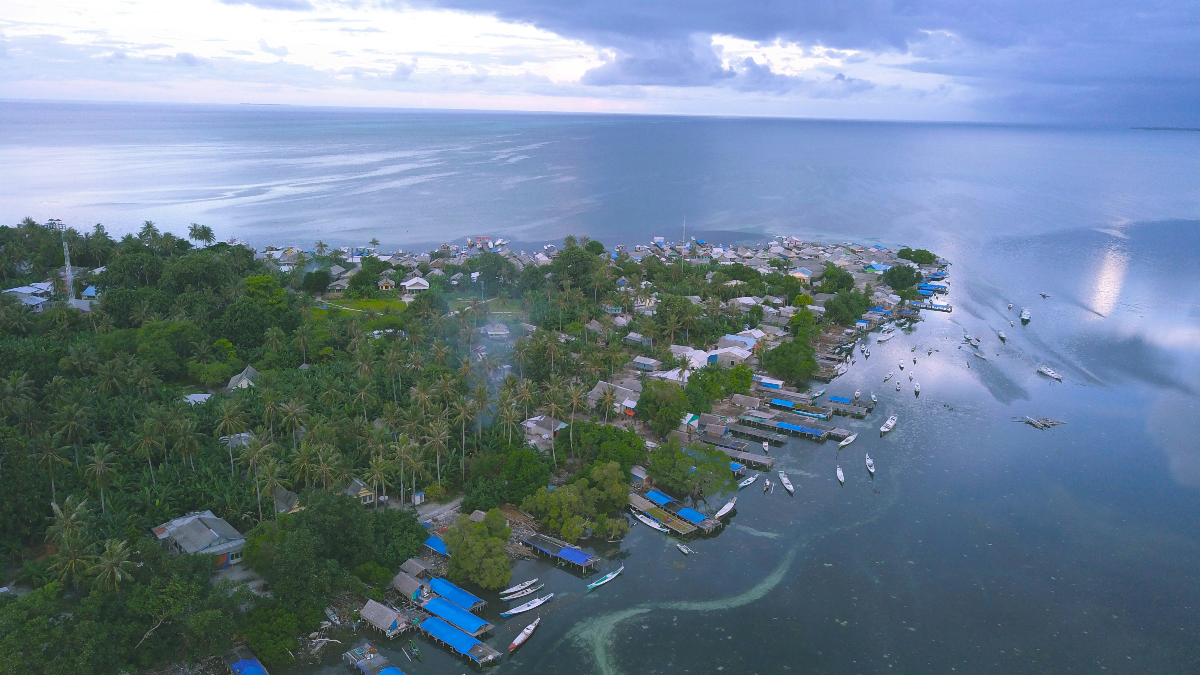 a body of water with buildings and trees around it, Pulau Dewakang Lompo or Pulau Dewakang Besar is one of the islands in the Spermonde Archipelago and is administratively included in the area of Dewakang Village, Liukang Kalmas District, Pangkajene and Islands District, South Sulawesi, Indonesia. Dewakang Lompo Island has an area of 2,952,225.0786000 m2