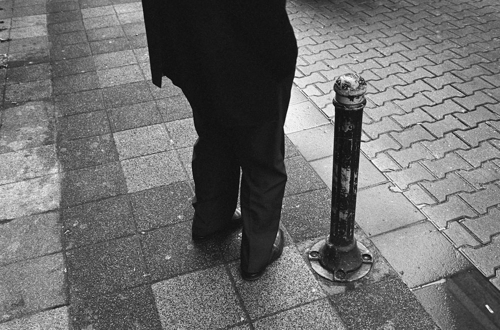 a person stands next to a fire hydrant