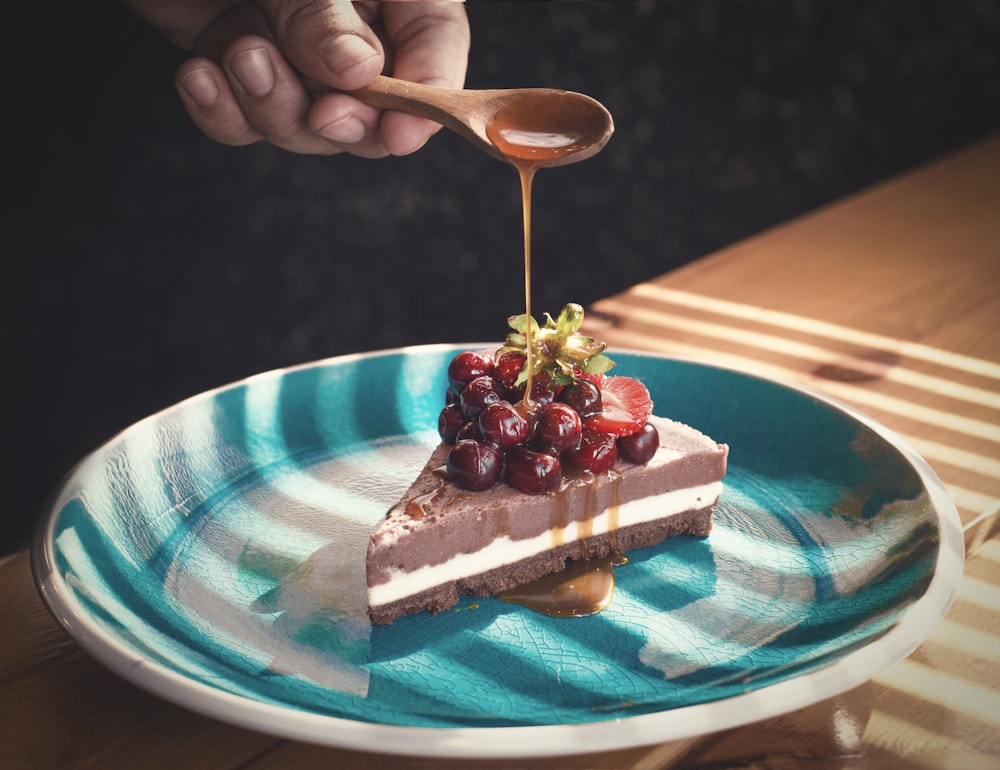 a person pouring a spoon into a cake