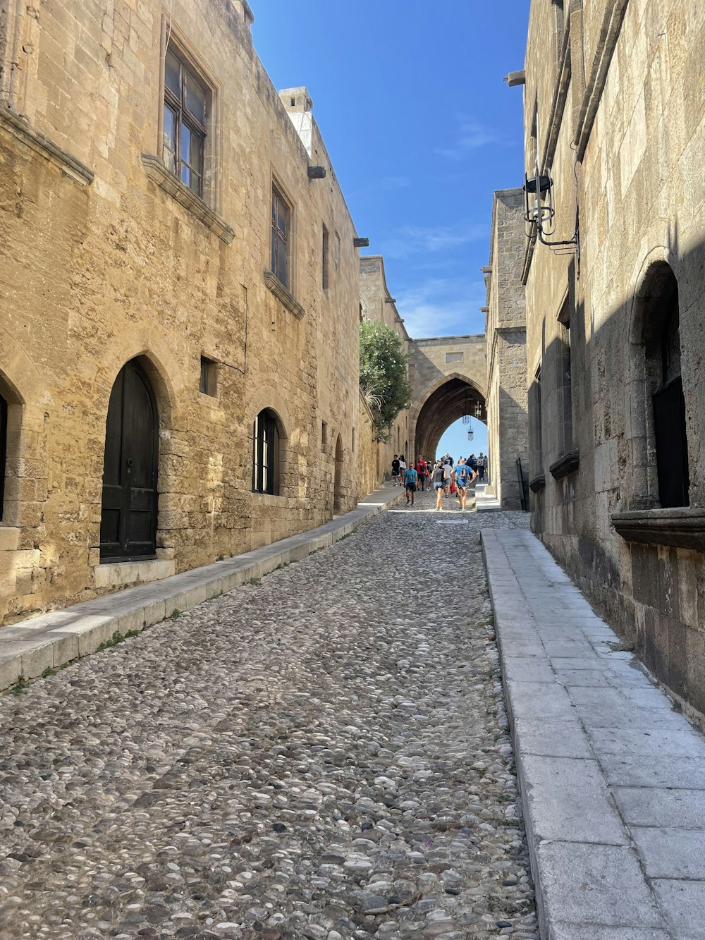 a cobblestone street between two buildings