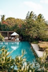 An inviting pool area surrounded by lush gardens.