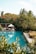 A bright and inviting pool area surrounded by greenery.