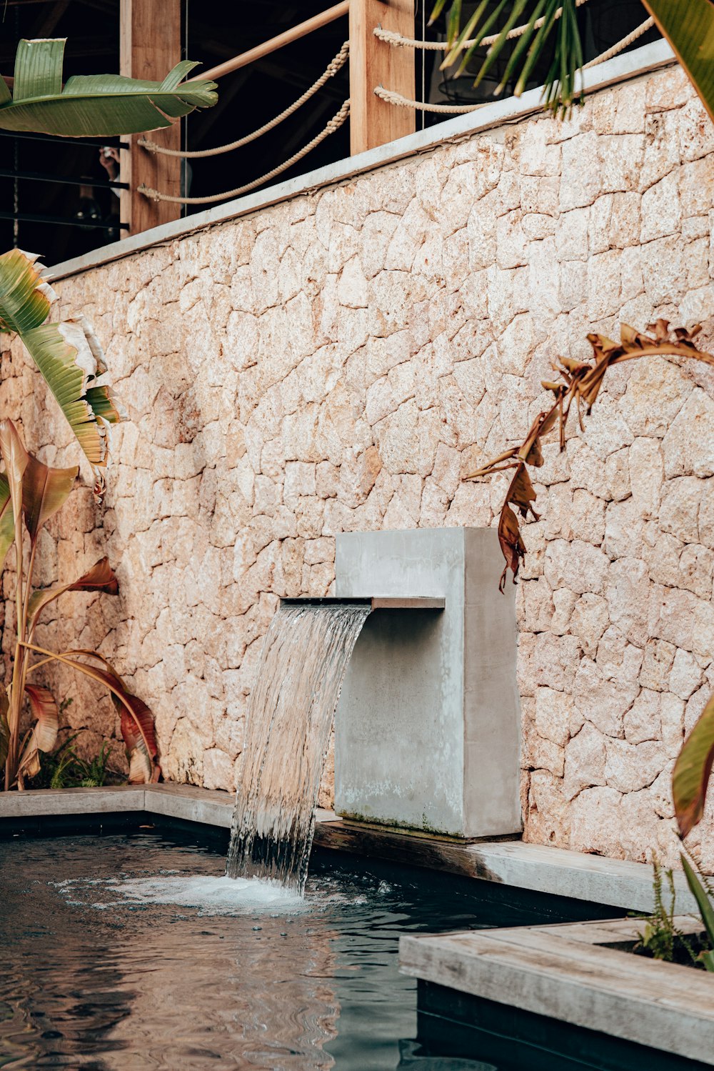 a water fountain in a stone building