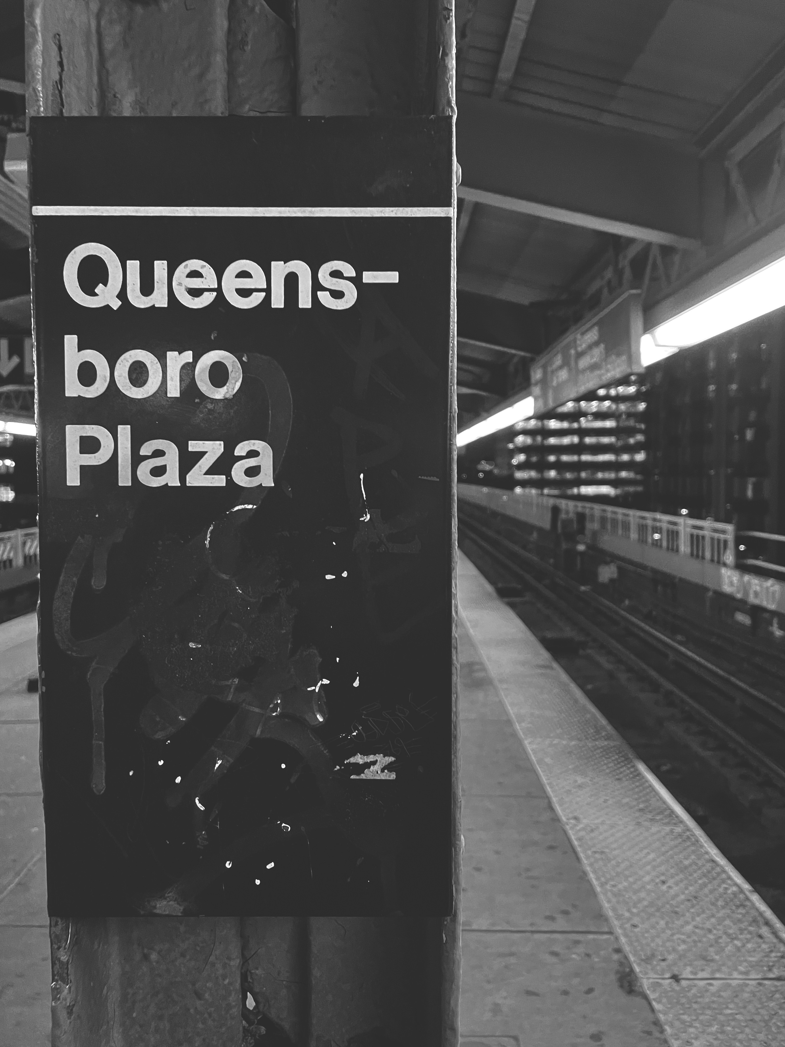 a sign on a train platform