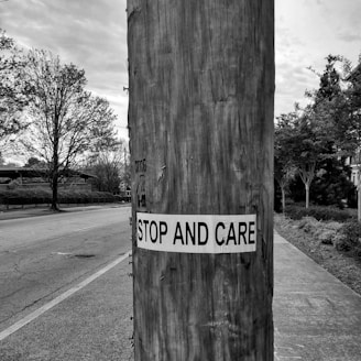 a sign on a wooden post