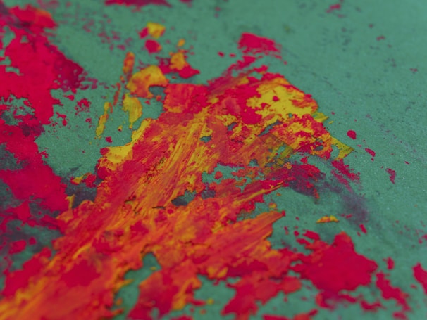 A vibrant abstract painting with bold red and orange strokes on canvas.