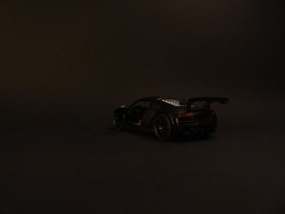 A sleek print ad showcasing a luxury car with a minimalist design and striking lighting.