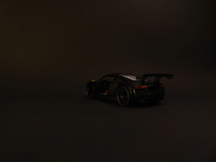 A sleek, hyper-realistic CGI rendering of a luxury product with sharp contrasts on a black background.