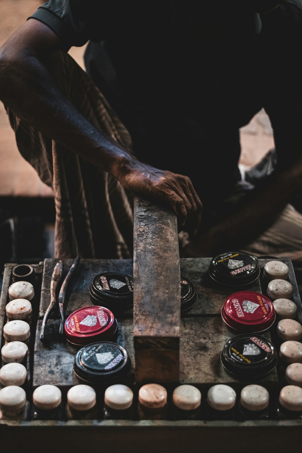 a person pouring a liquid into a container with a group of cigars