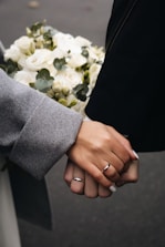 a person holding a bouquet of white flowers