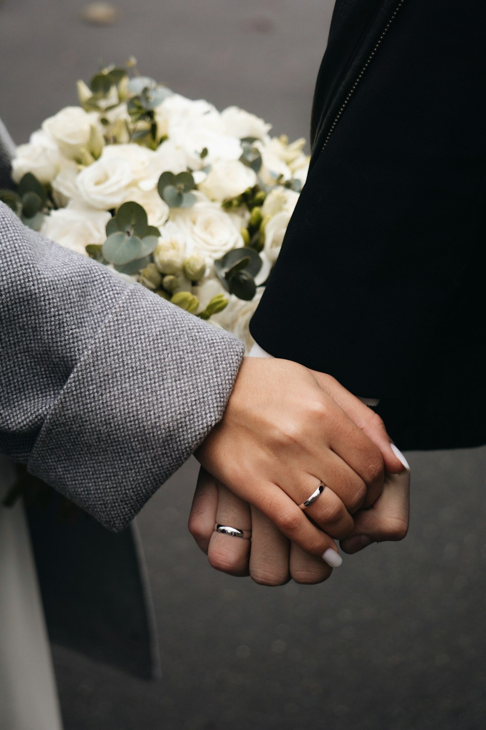 a person holding a bouquet of white flowers