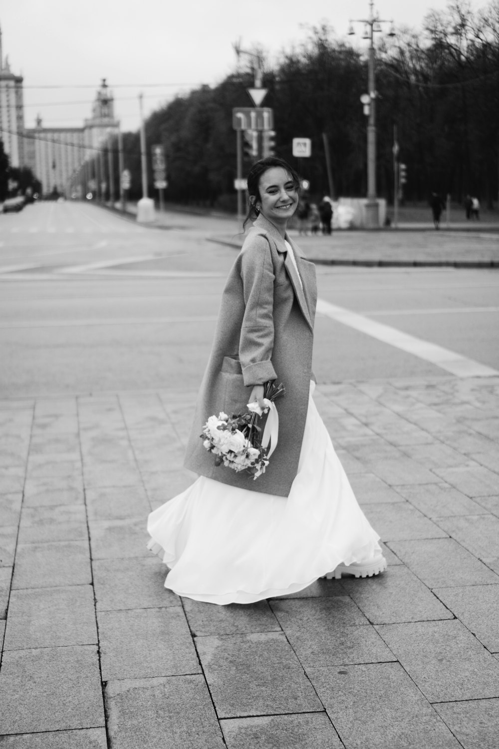 a person in a dress holding flowers