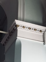 Architectural detail of a classic building facade with midnight blue and gold accents.