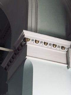 Architectural detail of a luxury home facade with marfil and gold accents.