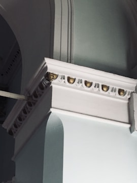 Premium architectural detail with navy and emerald color scheme.