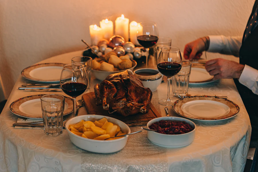 A candlelit holiday table set with dishes