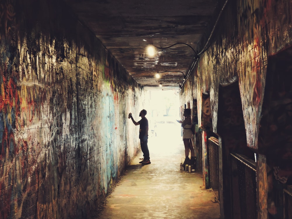 a couple of people in a narrow alley