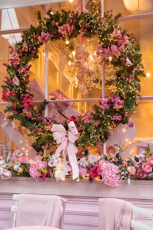 a room with a mirror and flowers