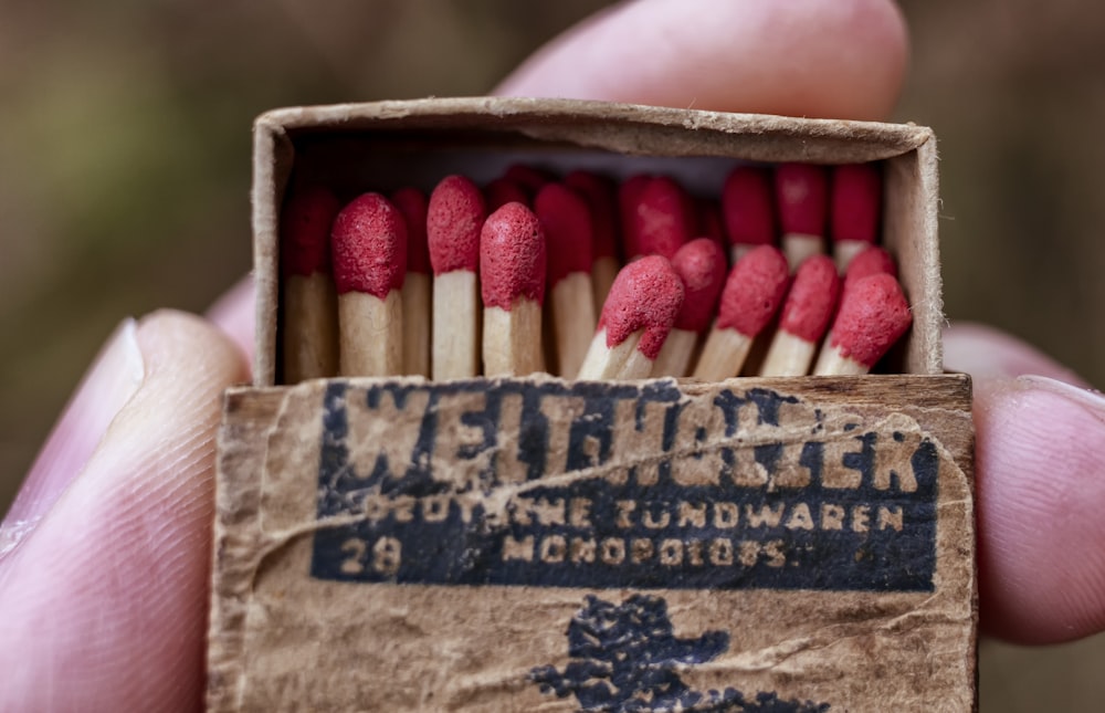 a hand holding a box of matches