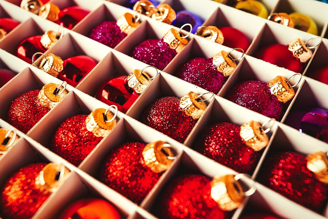 a tray of chocolates, Christmas balls in a carton