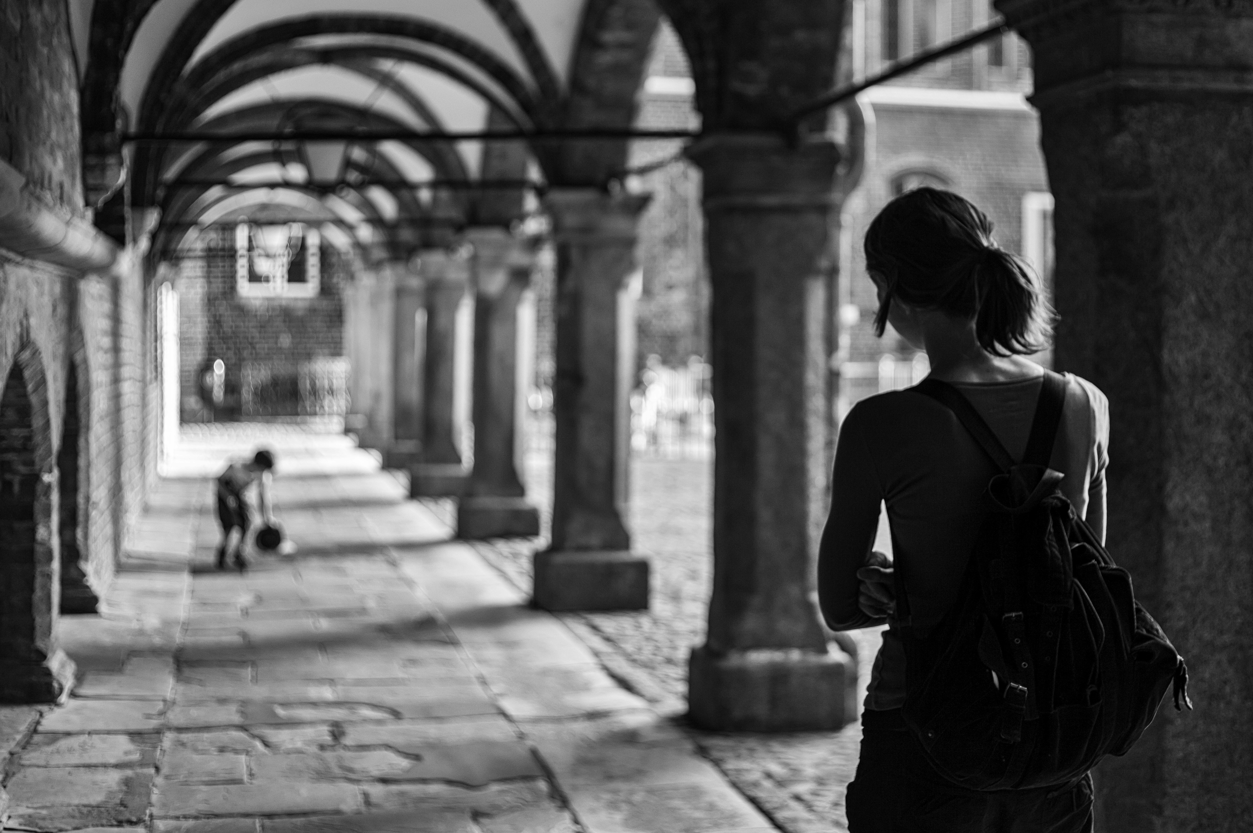 back view of a female tourist in lubeck black and white