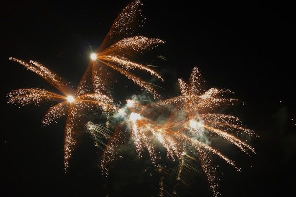 Colorful burst of traditional firecrackers lighting up a dark sky.