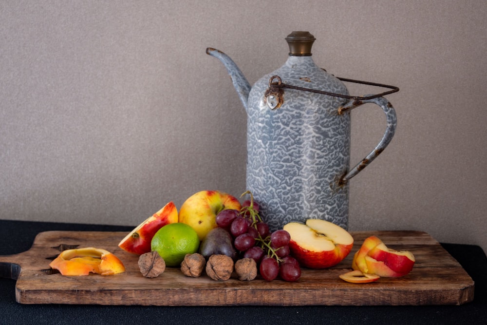 a table with fruits and a kettle