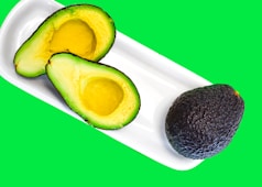 a cut avocado and a cut avocado on a plate