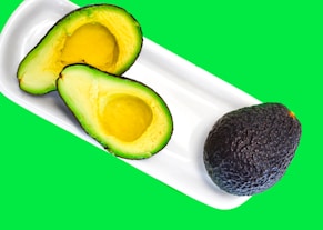 a cut avocado and a cut avocado on a plate