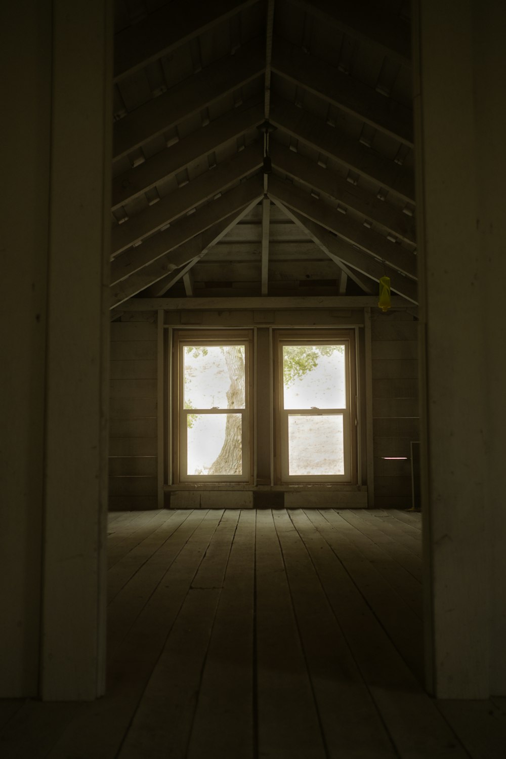 a room with a window and a wood floor