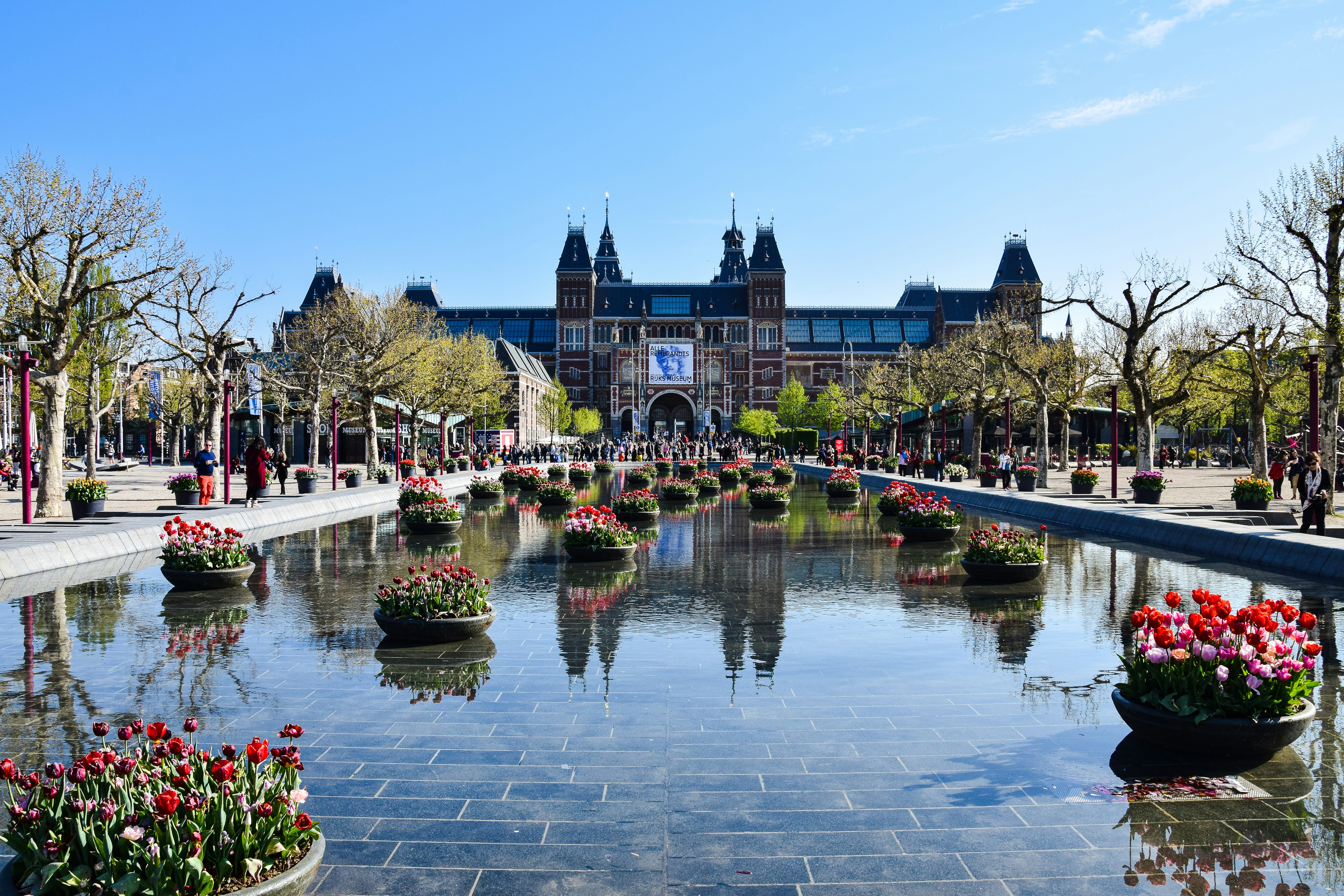 a large building with a pond in front of it, Amsterdam, Netherlands.