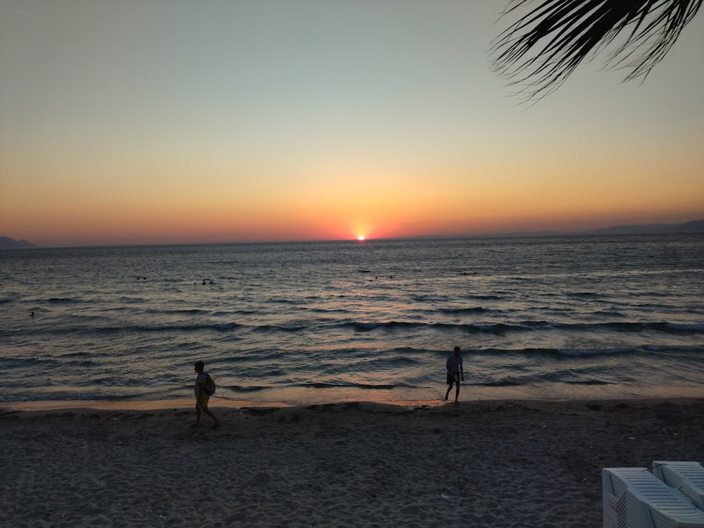 a couple people on a beach