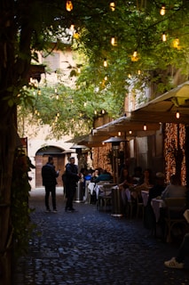 people sitting at tables outside