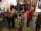 A group of elderly people exercising together in a bright, welcoming studio.
