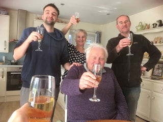 A smiling team celebrating the opening of their new kitchen space.