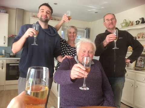 A smiling team celebrating the opening of their new kitchen space.
