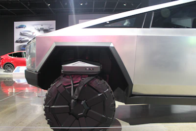 Futuristic automotive design blueprint with dark mode aesthetic and mesh network background.