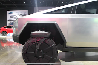 A vibrant collage showing a sleek transport vehicle alongside dynamic gaming scenes.