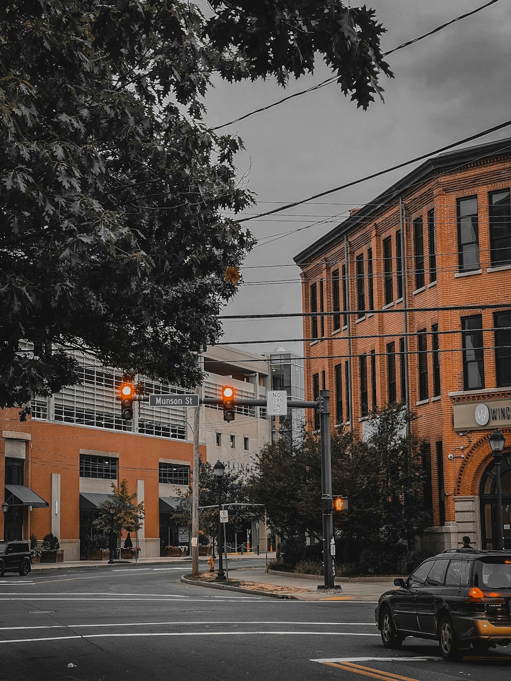 a street with a car on it and buildings on the side