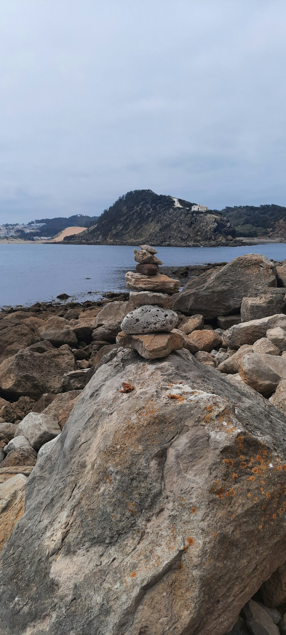 a group of rocks by a body of water