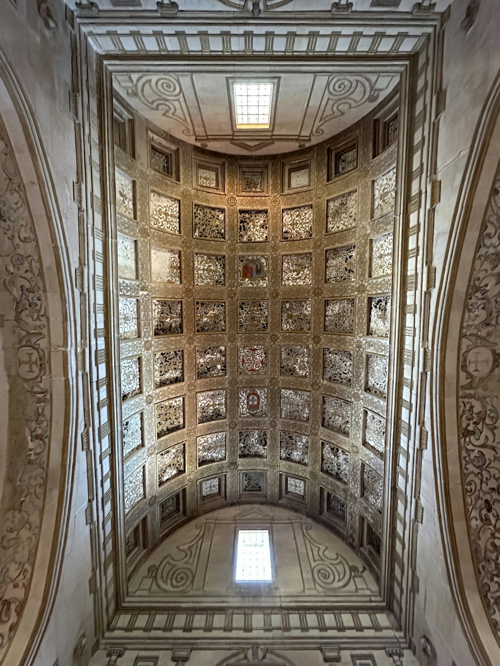 a large ornate ceiling with a window