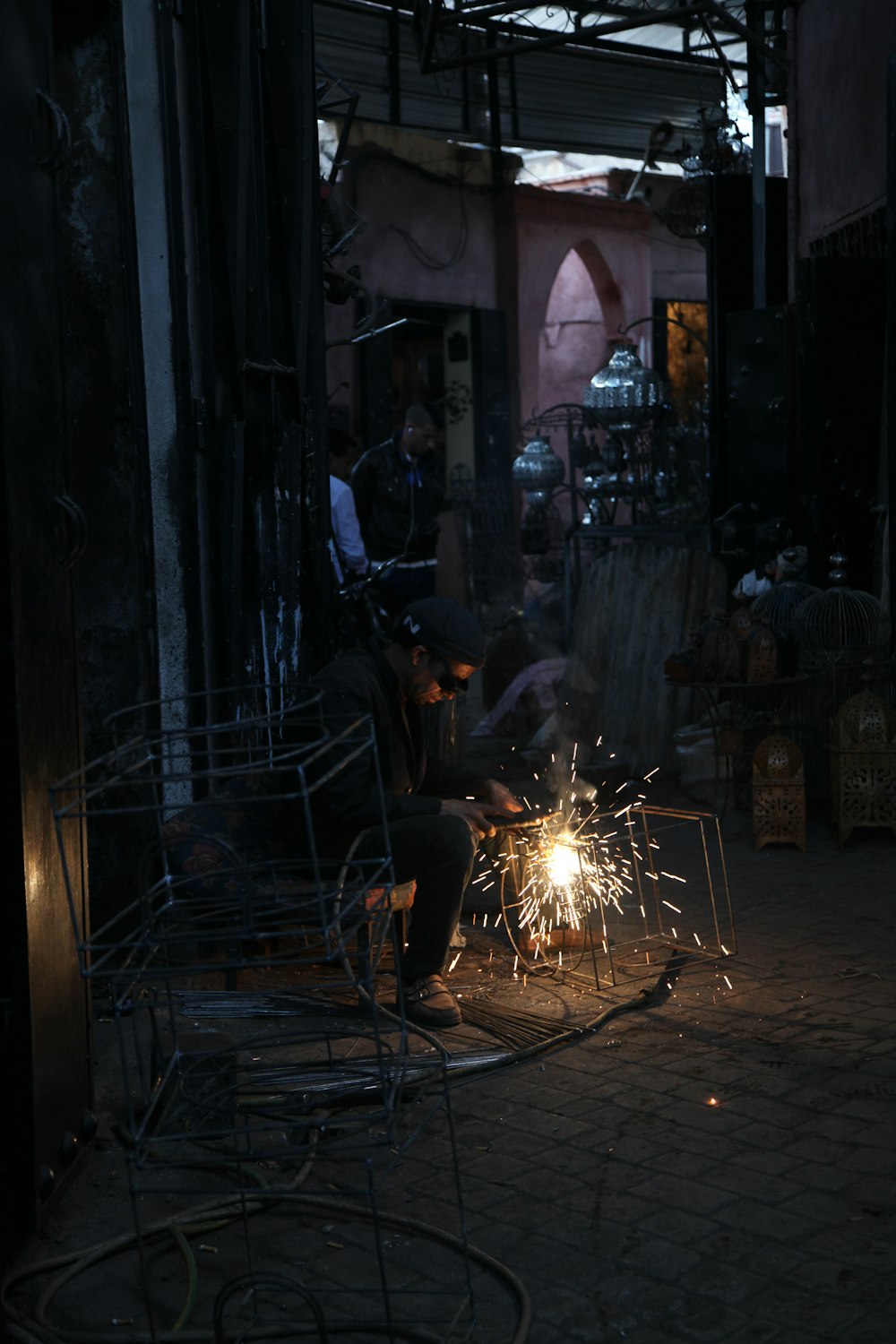 a person sitting at a table with a fire in front of him