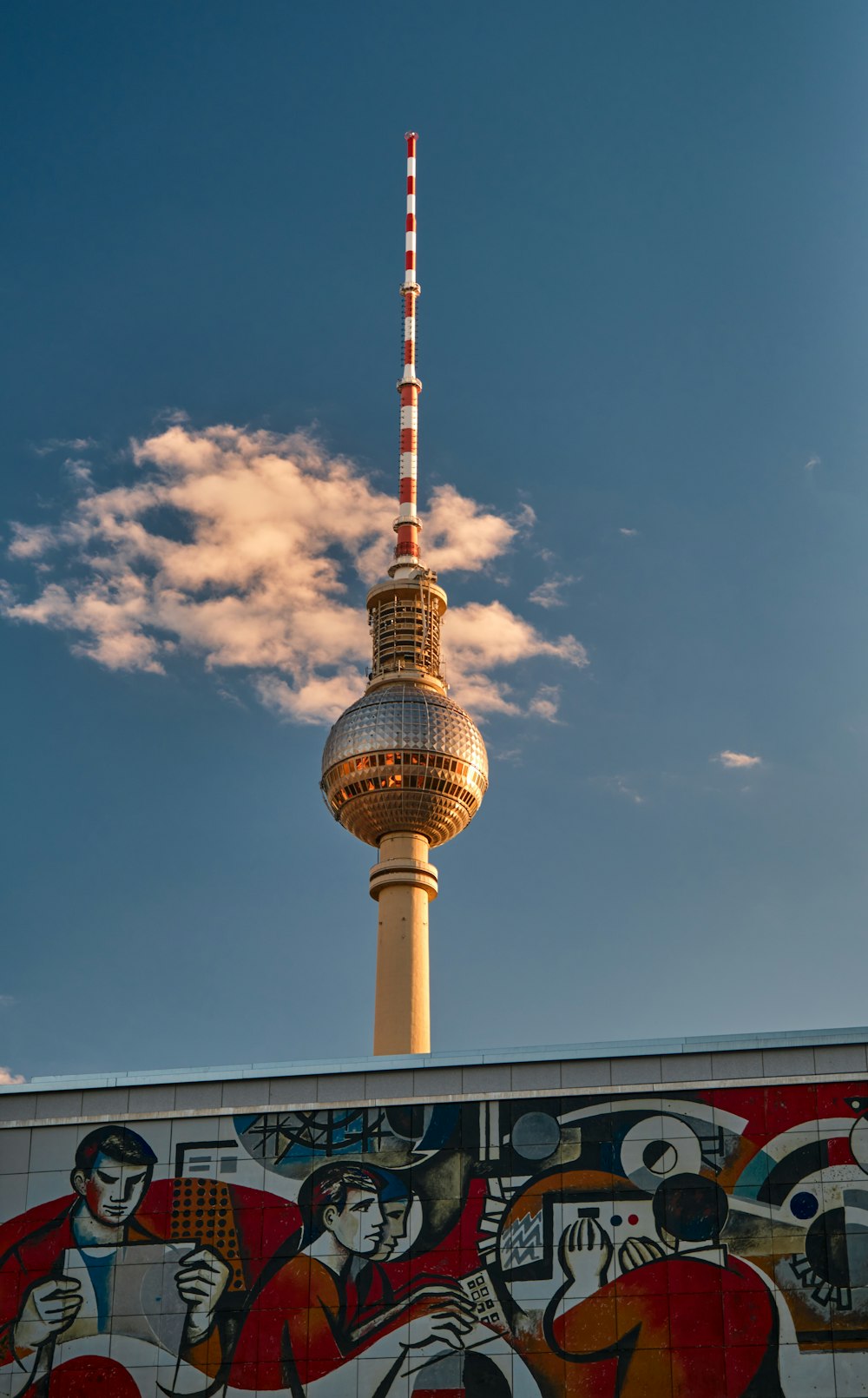 a tall tower with a cloud of smoke in the sky