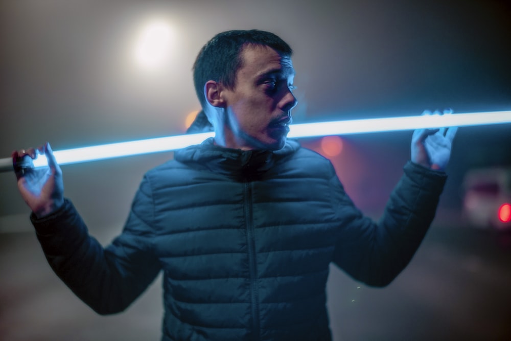 a man holding a light saber