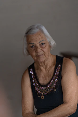 an older woman with a necklace