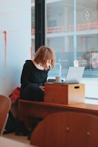 a person sitting at a desk with a laptop