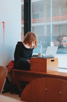 a person sitting at a desk with a laptop